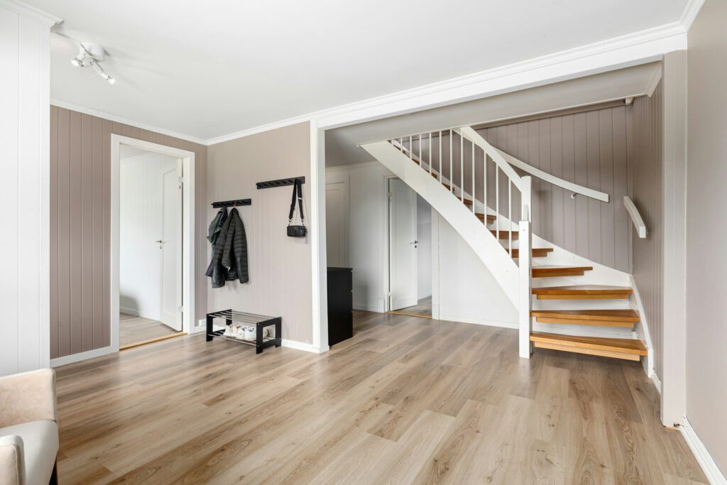 A living room filled with furniture and a staircase