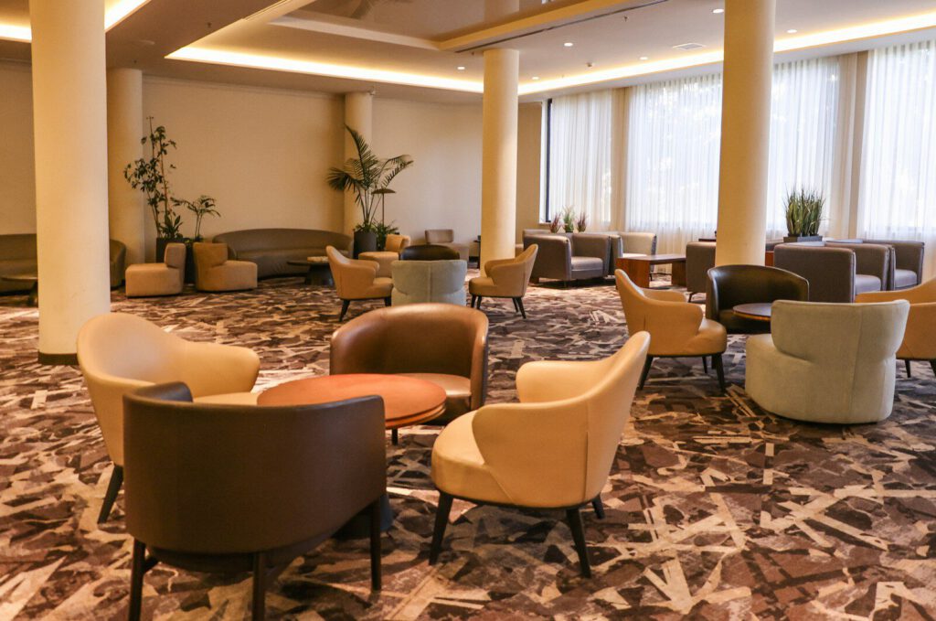 Modern lounge area with comfortable seating and abstract carpet.