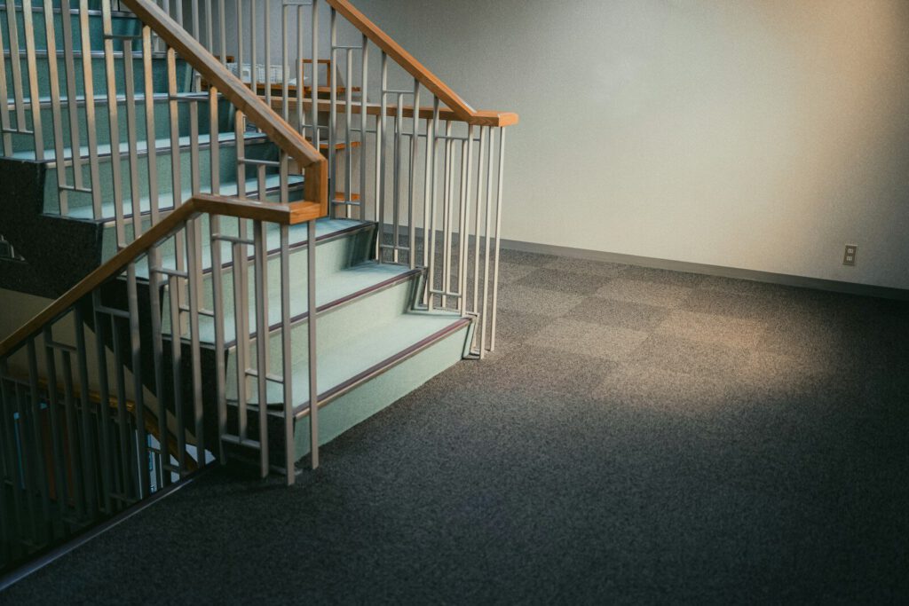 A modern staircase with carpeted floor.